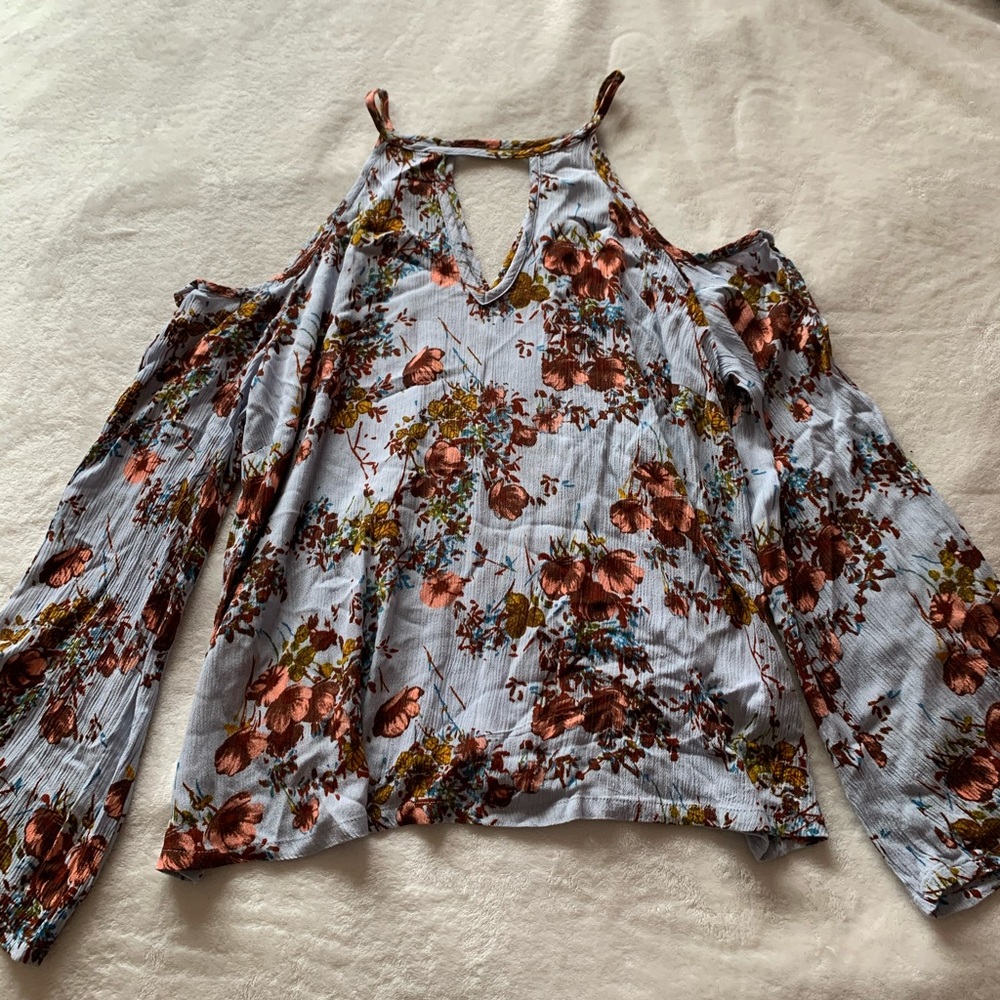 Open shoulder long sleeve blouse.